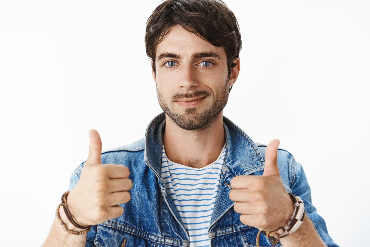 close up shot satisfied happy young attractive male with blue eyes bristle denim jacket raising thumbs up smiling cheerfully_176420 43528